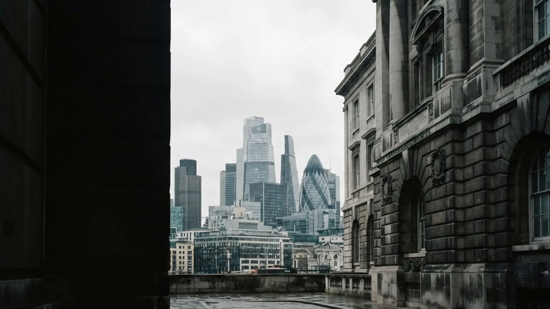 Historic London stonework set against contemporary financial architecture