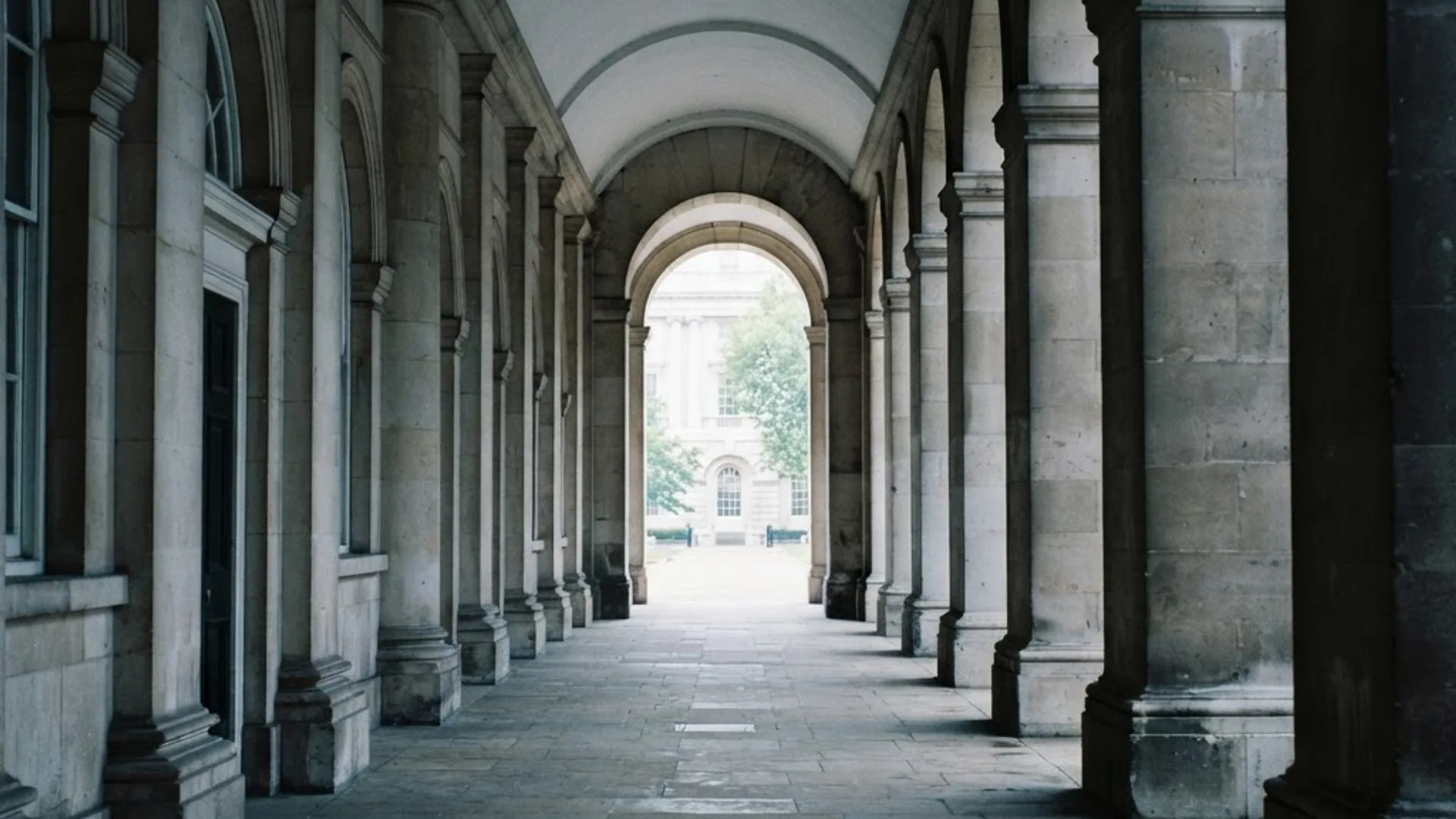 Orderly London colonnade leading toward daylight